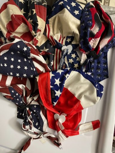 Various fabric masks adorned with American flag patterns in red, white, and blue.